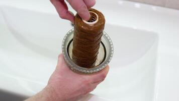 Plumber working replaceable dirty used water filter for filtration of reverse osmosis water video