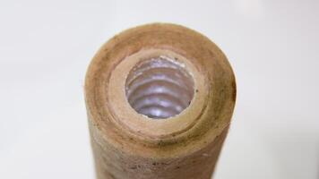 Used water filter with traces of dirt, clay and contamination spins in the bathroom. Dirty reverse osmosis filter after 1 year usage video