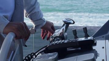 Close-up of the captain's hands at the helm. He controls the movement of the yacht. S video