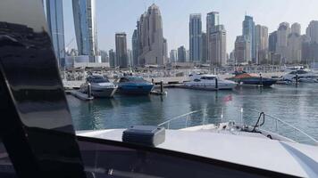 View of the marina with yachts with the Dubai in the background. View from a motor boat. video