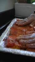 Chef arranges pieces of raw fish on a tray before frying video