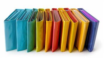 A neatly arranged row of vibrant, colorful file folders standing upright on a white background. photo