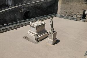 Statue and Terrace of Marcus Nonius Balbus with his crypt in front c. 30 BC, Roman Ruins of Herculaneum that was buried and preserved by pyroclastic mud from the 79 AD eruption of Mount Vesuvius. photo