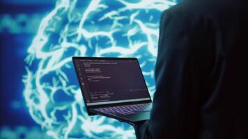 Technician uses laptop and AI neural networks modeled after human brain to solve complex problems. Close up of worker using deep learning to look at data and complete tasks, camera B video