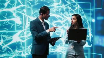 Software developers use neural networks modeled after human brain to solve complex problems. IT specialists in high tech workspace using artificial intelligence to look at data video