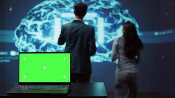 Startup coworkers using AI software on chroma key notebook to take data driven decisions. Close up of isolated screen laptop used for developing artificial intelligence solutions, camera B video