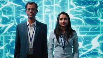 Portrait of smiling team of technicians implementing artificial intelligence parallel processing, breaking up complex computational tasks enabling AI systems to process data faster, camera A video