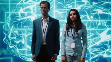 Admins using artificial intelligence computing simulating human brain thought processes in computerized model. Portrait of employees working with AI machine learning algorithms, camera A video