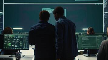 Cyber security team conducting cyber surveillance in a governmental control room. Experts group hacking activities, malware protection and data breach prevention in high tech agency. Camera B. video