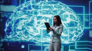 Developer using tablet to implement artificial intelligence parallel processing, breaking up complex computational tasks enabling AI systems to process more input data faster, camera B video