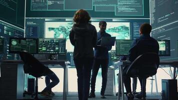 Governmental hackers performing a cyber attack simulation after studying the national database servers. Experts working on IT security, data breach prevention against ransomware. Camera B. video
