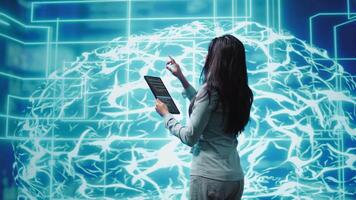 Computer scientist using artificial intelligence computing simulating human brain thought processes. Indian employee working on tablet, developing AI machine learning algorithms, camera B video