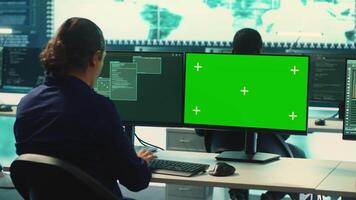 Governmental hackers using green screen in performing cyber security monitoring and threat detection. Examining network security and protection against cyber attacks, national intelligence. Camera A. video