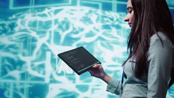 Engineer uses tablet and AI deep neural networks modeled after human brain to solve complex problems. Close up of admin using machine learning model to look at data and better complete tasks, camera B video