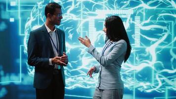 Computer scientists use AI neural networks modeled after human brain to solve complex problems. Startup employees using artificial intelligence to look at data and complete tasks, camera A video
