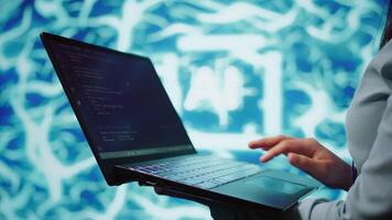 Engineer using notebook to maintenance artificial intelligence neural networks. Close up shot of IT expert using AI system aiding in processing and transmitting information, camera B video