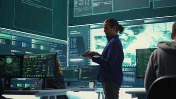 Governmental hacking team launches phishing attack to steal passwords and personal data for cyberwarfare tactics. Group of IT experts working to penetrate a database in monitoring room. Camera B. video
