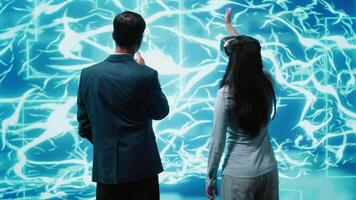 Engineers use VR headset and AI neural networks modeled after human brain to solve complex problems. IT experts using artificial intelligence and virtual reality tech to look at data, camera A video