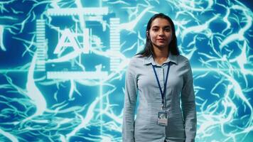 Jolly engineer using artificial intelligence computing simulating human brain thought processes. Portrait of upbeat Indian employee working with AI machine learning algorithms, camera A video