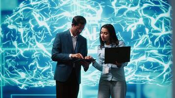 Teamworking colleagues using AI neural networks modeled after human brain to solve complex problems. Team of IT specialists using deep learning to look at data and complete tasks, camera A video