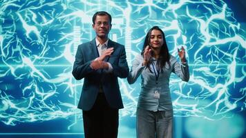 Portrait of cheerful team of admins using artificial intelligence computing simulating human brain. Smiling colleagues working with AI machine learning algorithms, camera A video