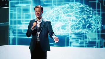 Upbeat presenter inviting engineer on stage during global IT conference to talk about subjects such as enterprise AI, deep learning, big data, neural networks and cognitive computing, camera A video
