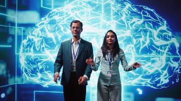 Portrait of cheerful team of admins using artificial intelligence computing simulating human brain. Smiling colleagues working with AI machine learning algorithms, camera B video