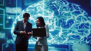 Teamworking colleagues using AI neural networks modeled after human brain to solve complex problems. Team of IT specialists using deep learning to look at data and complete tasks, camera B video