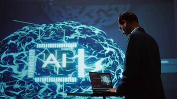 Startup employee looking over business charts, using AI software to take data driven decisions in tech industry. IT expert developing innovative artificial intelligence solutions for company, camera B video