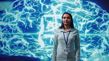 Jolly engineer using artificial intelligence computing simulating human brain thought processes. Portrait of upbeat Indian employee working with AI machine learning algorithms, camera B video