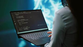 Engineer using notebook to maintenance artificial intelligence neural networks. Close up shot of IT expert using AI system aiding in processing and transmitting information, camera A video