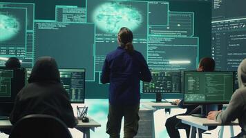 Group of professional hackers gaining access into government database to steal important information for hybrid warfare. Experts work on scams and phishing activity in high tech office. Camera A. video