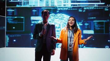 Tech specialists discussing during keynote summit presentation, exploring successful implementation of AI in driving forward businesses, sharing latest artificial intelligence innovations, camera B video