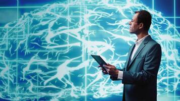 IT specialist coding on tablet, programming artificial intelligence computing simulating human brain. Programmer using technology gear to build AI machine learning algorithms, camera B video