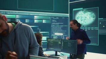 Governmental cyber defense team using advanced technology to secure information, cyber operations in high tech monitoring center. Working on data protection and threat detection. Camera B. video