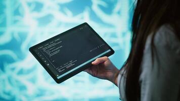 Engineer uses tablet and AI deep neural networks modeled after human brain to solve complex problems. Close up of admin using machine learning model to look at data and better complete tasks, camera A video