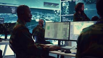 Telecommunications operator transmitting live information from satellite CCTV footage, supporting field troops with essential data. Federal agency working on reconnaissance system. Camera B. video