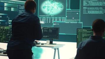 Governmental hacking group targeting sensitive information through high tech cyber attacks, digital espionage. Team of IT experts working on national security and data privacy servers. Camera A. video