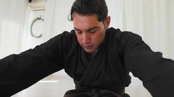 Man Does Stretching In Gym With Karate Uniform video