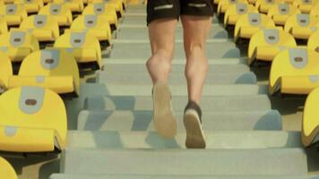 A person is running up a set of stairs. Concept of determination and physical exertion video