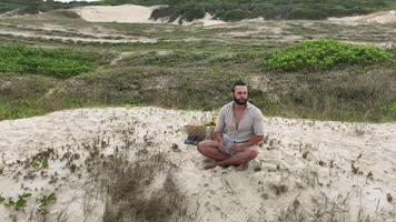 Man eating fruit and drinking water during picnic on the beach. Frontal Camera. video