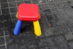 A lounge chair stands on the sidewalk on a street in a big city. photo