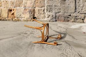 A lounge chair stands on the sidewalk on a street in a big city. photo