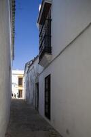 Typical Mediterranean architecture with whitewashed walls and narrow streets in the historical city of Carmona, province of Seville, Spain photo