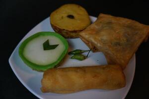 Indonesian traditional snack that called Jajanan Pasar with various color and different taste. The snack name is lumpur risol and martabak telur. photo