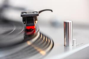 Close Up of Vinyl Record Playing on Turntable in Bright Setting photo
