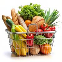 Basket full of groceries and vegetables isolated on a white background photo