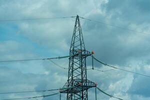 High voltage towers with sky background. Power line support with wires for electricity transmission. High voltage grid tower with wire cable at distribution station. Energy industry, energy saving photo