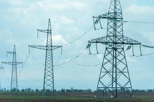 High voltage towers with sky background. Power line support with wires for electricity transmission. High voltage grid tower with wire cable at distribution station. Energy industry, energy saving photo