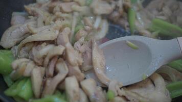 Cooking Chicken Stirfry with Vegetables in a Pan involves stirfrying ingredients on a stovetop video